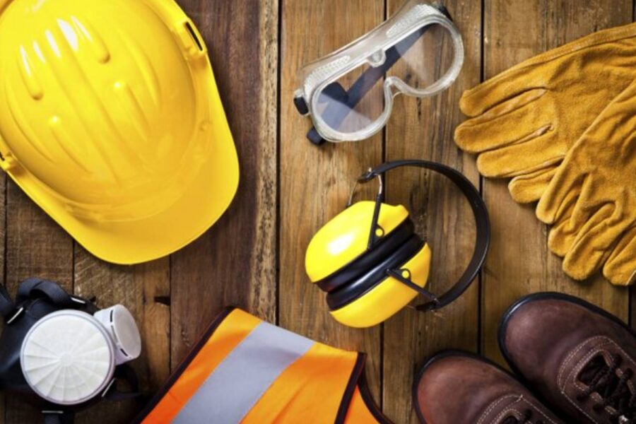 Personal safety workwear on rustic wood background shot directly above